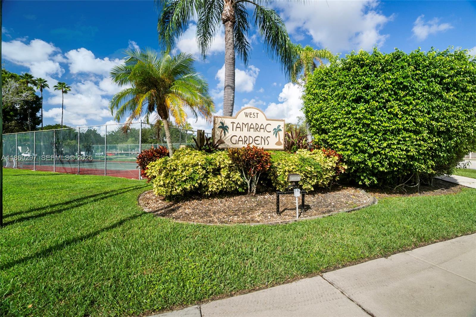 9606 West McNab Road, Unit 202 Tamarac, FL 33321 - Photo 3 of 29 a view of a garden with a fountain