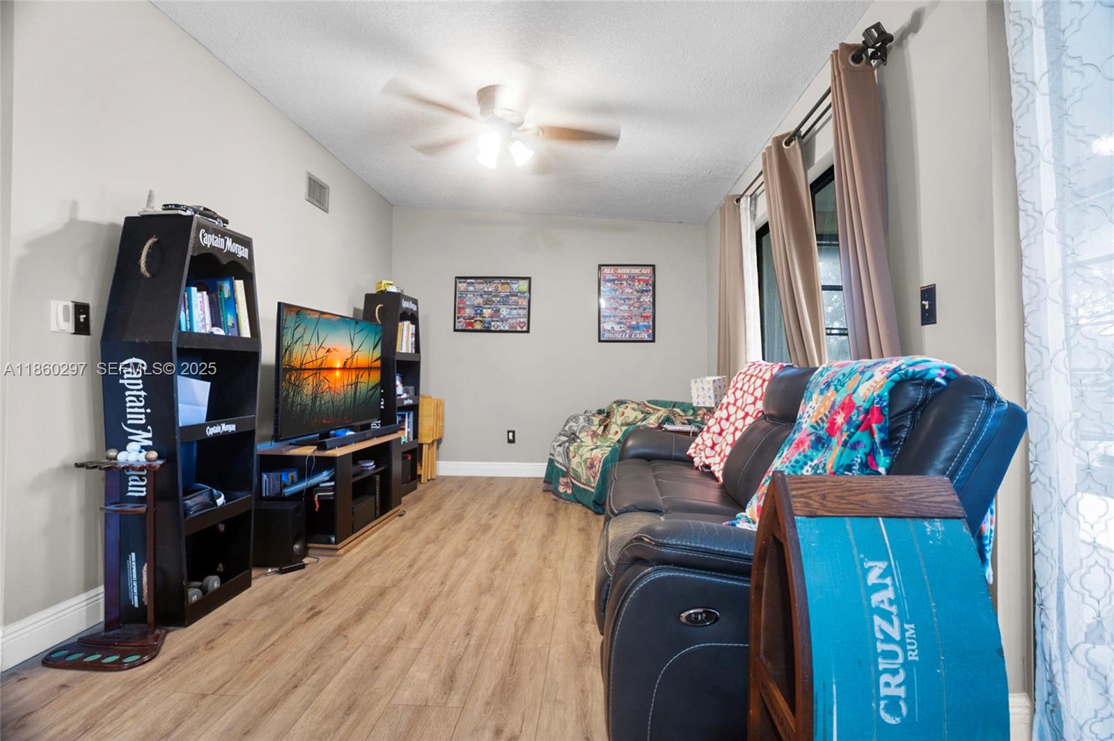 9606 West McNab Road, Unit 202 Tamarac, FL 33321 - Photo 7 of 29 a living room with furniture and a flat screen tv