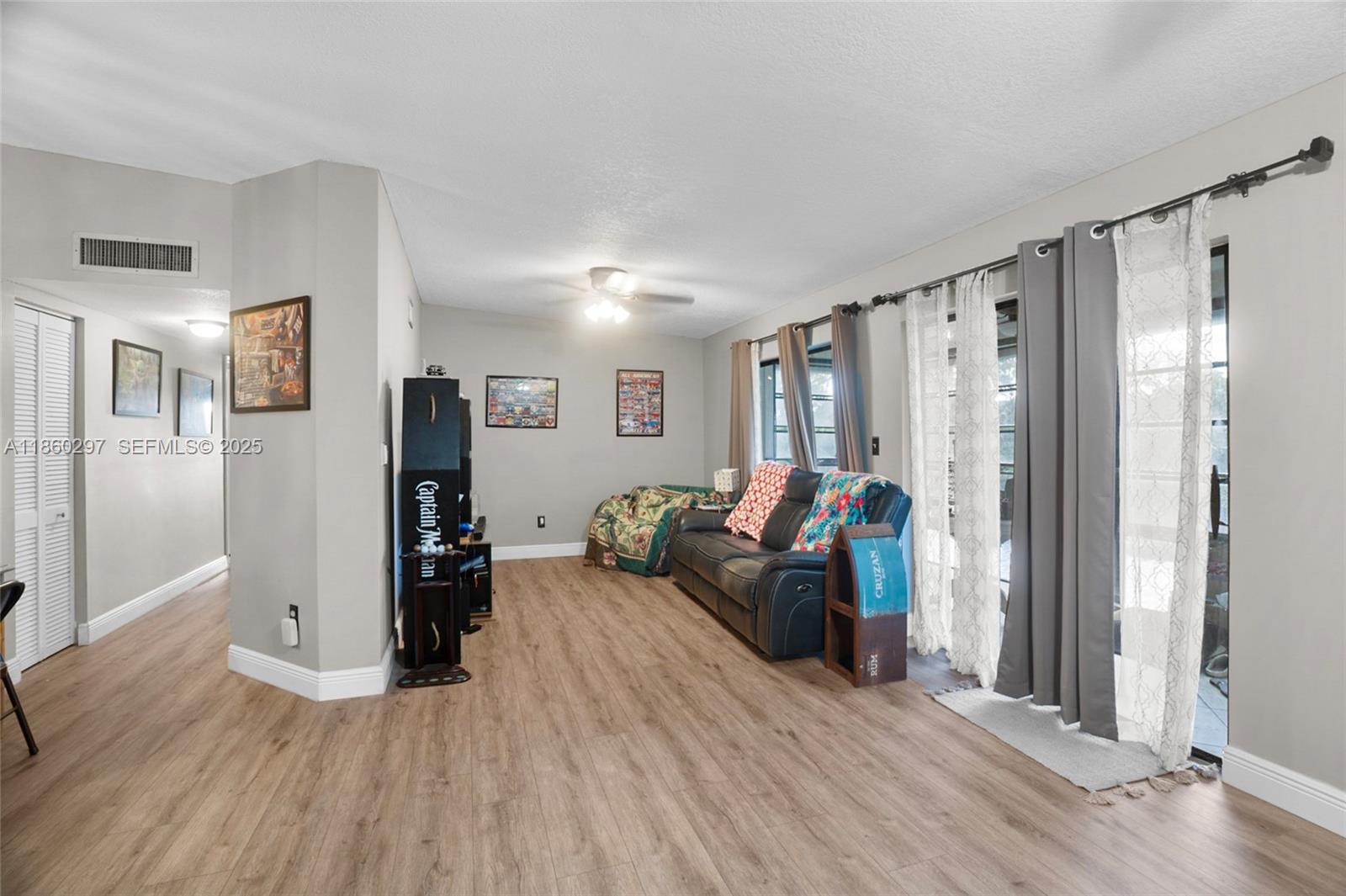 9606 West McNab Road, Unit 202 Tamarac, FL 33321 - Photo 8 of 29 a living room with furniture and a wooden floor