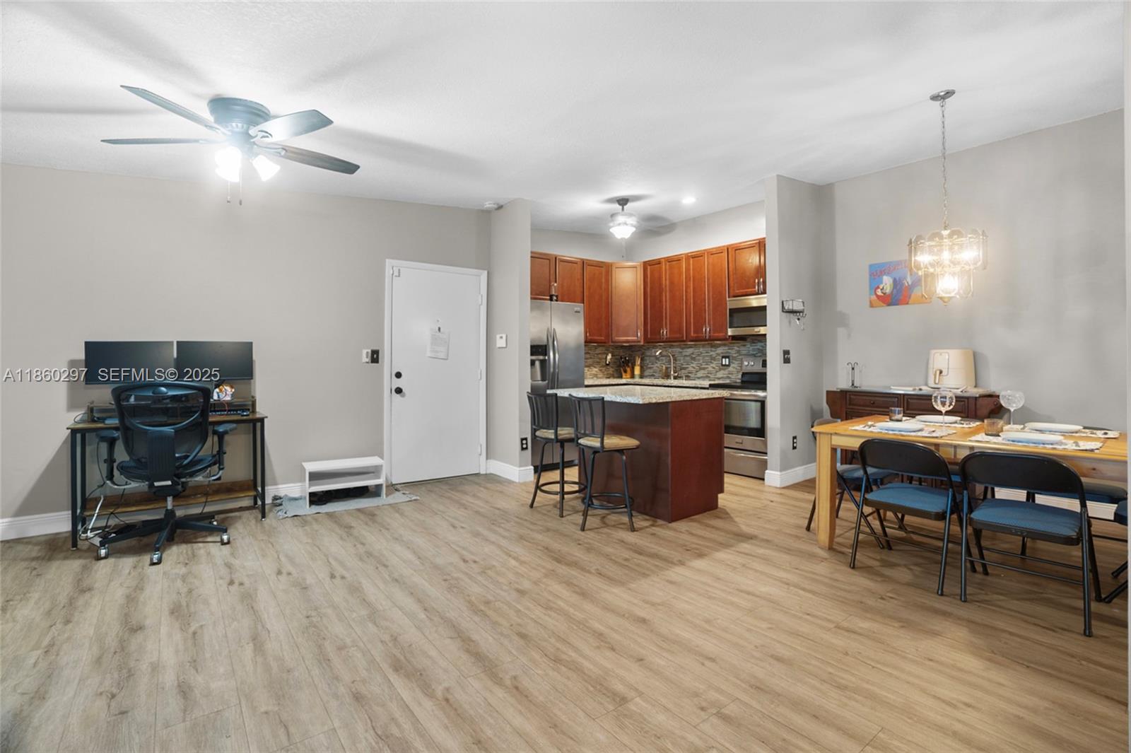 9606 West McNab Road, Unit 202 Tamarac, FL 33321 - Photo 9 of 29 a open kitchen with a table and chairs in it