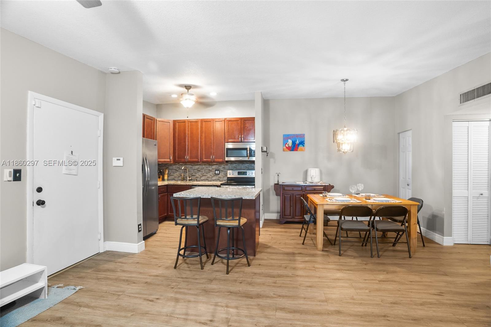 9606 West McNab Road, Unit 202 Tamarac, FL 33321 - Photo 10 of 29 a view of a dining room with furniture and wooden floor