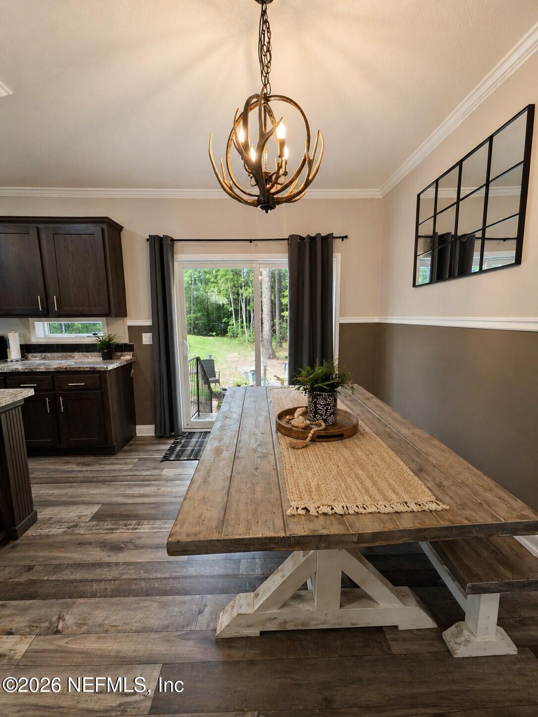 124 Jack Road Palatka, FL 32177 - Photo 4 of 18 a view of a dining room with furniture a chandelier and wooden floor