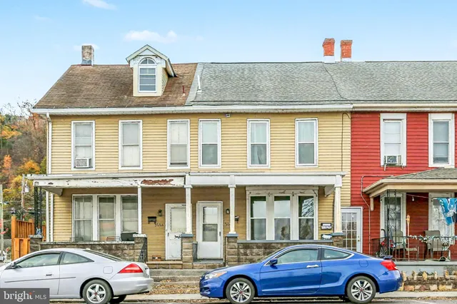 a front view of a house with parking space