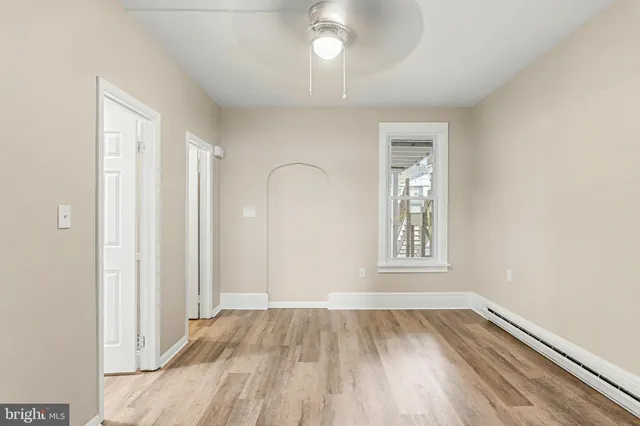 wooden floor in an empty room with a window