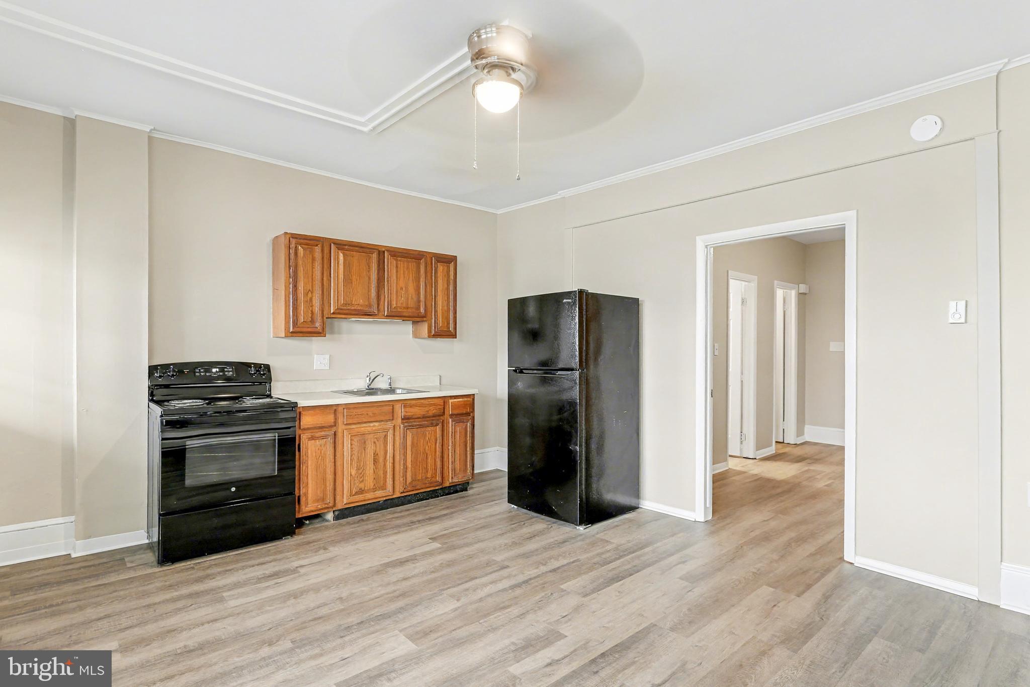 306 South Front Street, Unit A Wormleysburg, PA 17043 - Photo 3 of 6 a kitchen with a refrigerator and a stove top oven