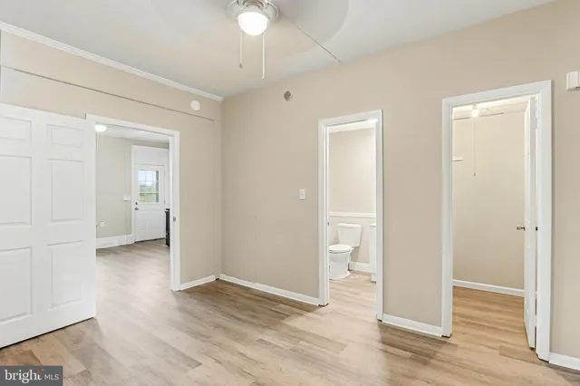an empty room with wooden floor and a window