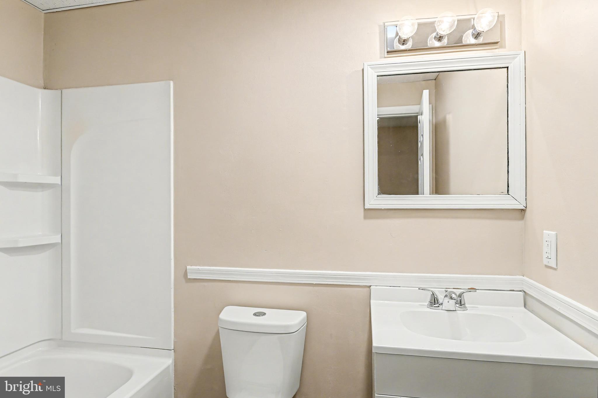 306 South Front Street, Unit A Wormleysburg, PA 17043 - Photo 6 of 6 a bathroom with a sink a toilet and shower