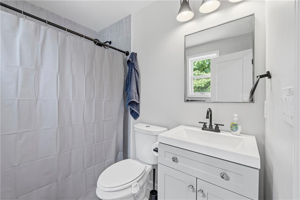 156 Pine Avenue Commerce, GA 30529 - Photo 7 of 35 a bathroom with a sink vanity mirror and toilet