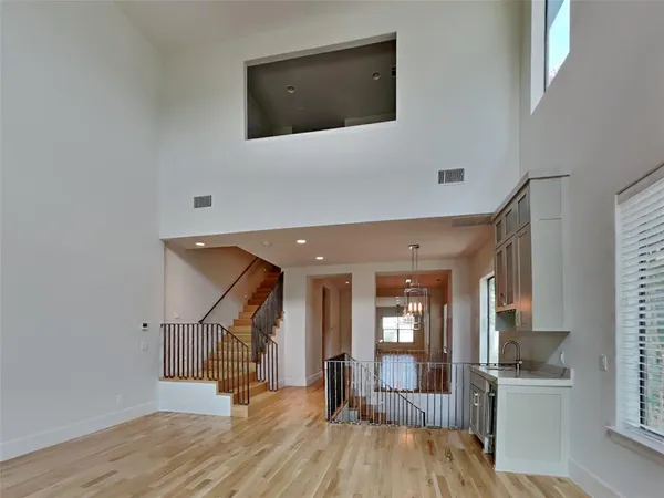 a view of a hallway with wooden floor and staircase