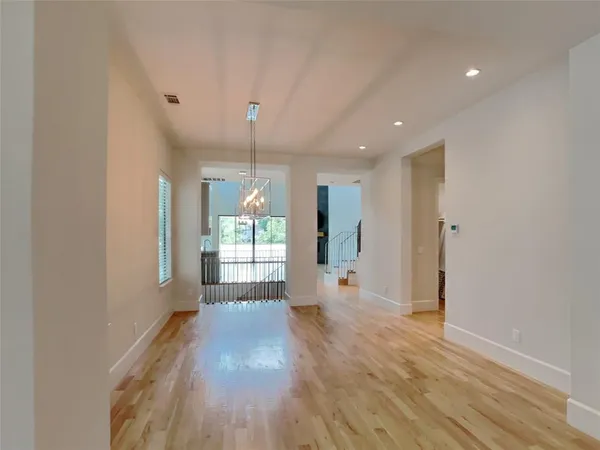 a view of a big room with wooden floor and a window