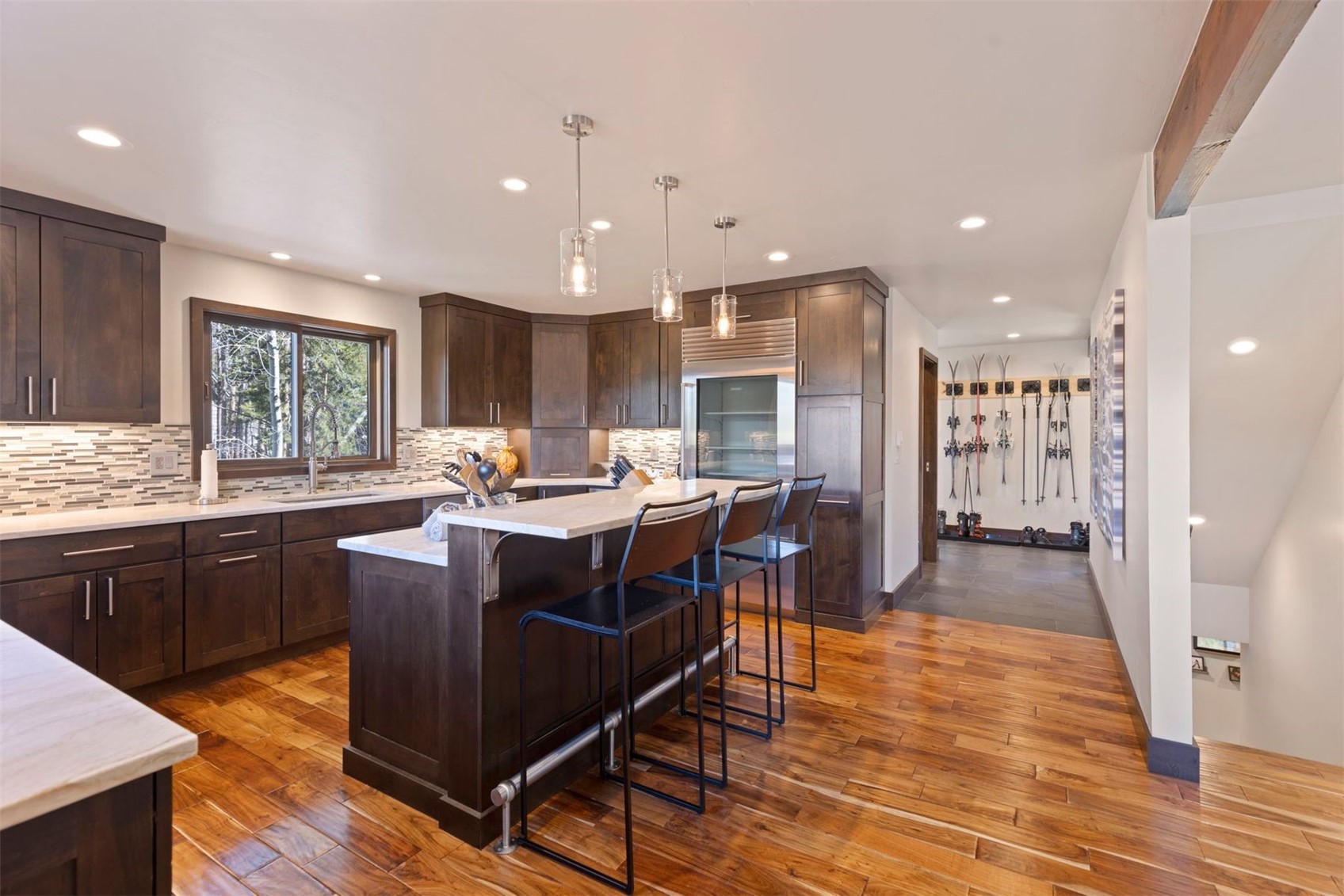 103 Bearing Tree Road Breckenridge, CO 80424 - Photo 15 of 30 a kitchen with stainless steel appliances granite countertop a table chairs sink refrigerator and cabinets