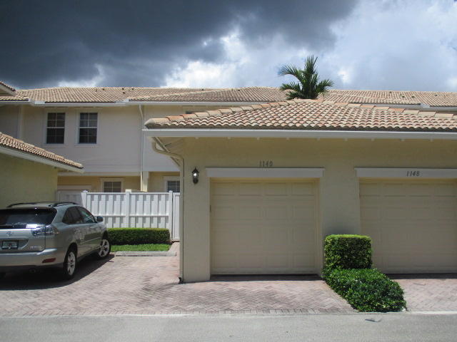 1140 Northwest 18th Avenue Boca Raton, FL 33431 - Photo 2 of 18 a front view of a house with a yard