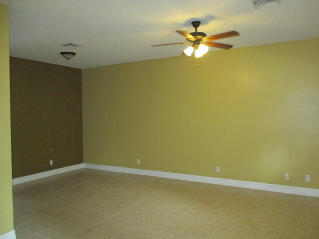 1140 Northwest 18th Avenue Boca Raton, FL 33431 - Photo 5 of 18 an empty room with a ceiling fan and window
