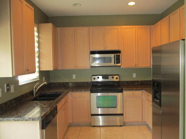 1140 Northwest 18th Avenue Boca Raton, FL 33431 - Photo 6 of 18 a kitchen with stainless steel appliances granite countertop a stove a sink and a microwave