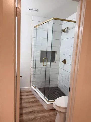 a bathroom with a shower and toilet