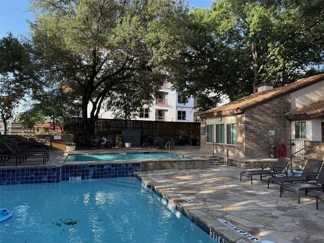 a swimming pool view with a outdoor seating