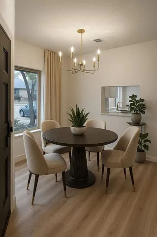 a view of a dining room with furniture and wooden floor