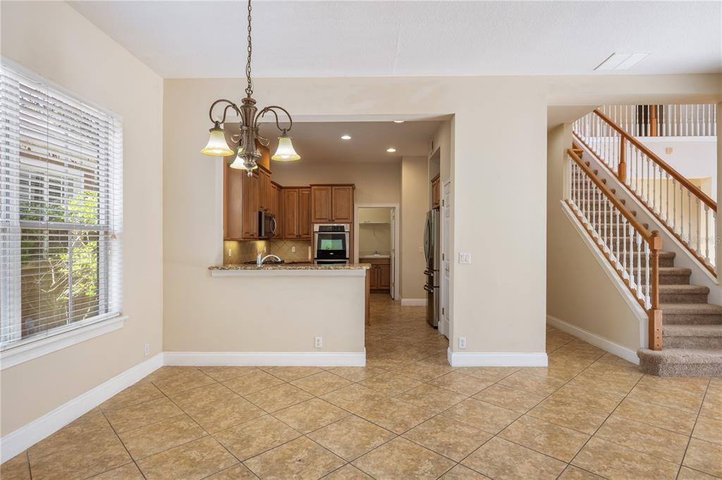 11905 Camden Park Drive Windermere, FL 34786 - Photo 18 of 32 a view of a hallway with wooden floor and a chandelier