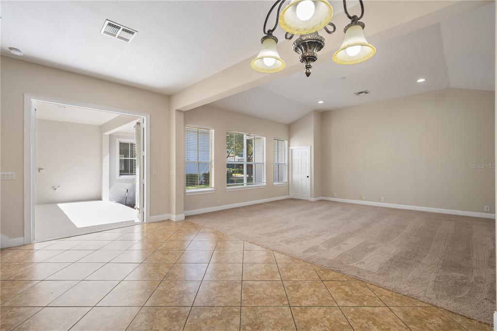 11905 Camden Park Drive Windermere, FL 34786 - Photo 20 of 32 a view of an empty room with a chandelier fan