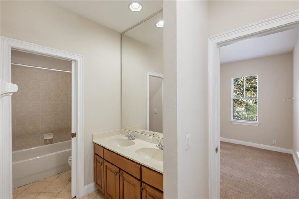 11905 Camden Park Drive Windermere, FL 34786 - Photo 25 of 32 a bathroom with a granite countertop sink a toilet and shower