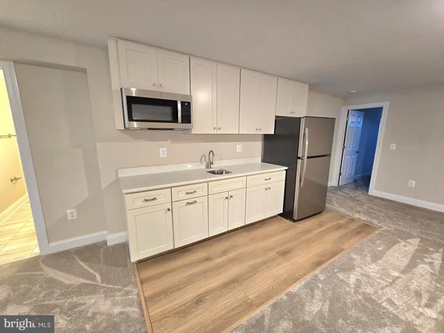 a bathroom with a sink a toilet a mirror and shower