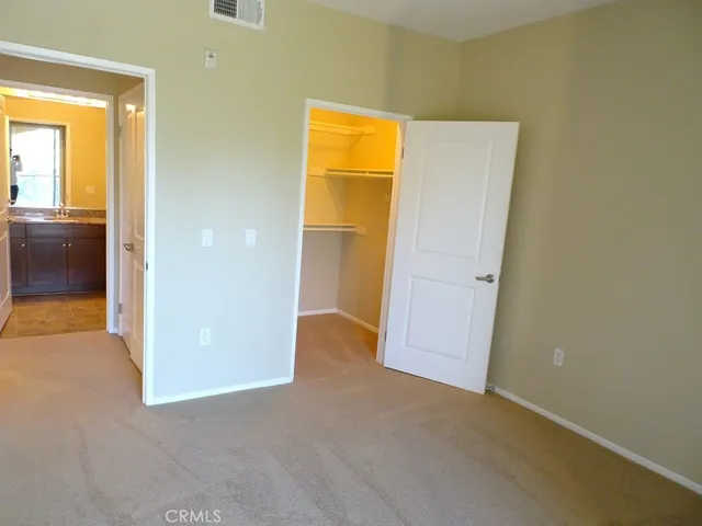 a bathroom with a granite countertop bathtub shower sink vanity and toilet