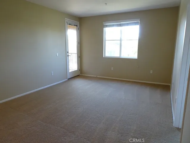 a view of a kitchen with a sink and a refrigerator