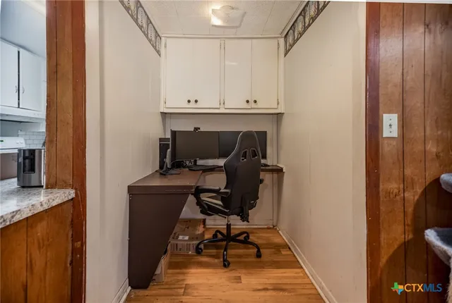 a view of workspace with wooden floor windows