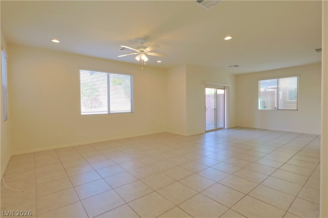 8663 Reynolds Spring Street Las Vegas, NV 89178 - Photo 6 of 32 Tiled flooring and large windows enhance this versatile living space.