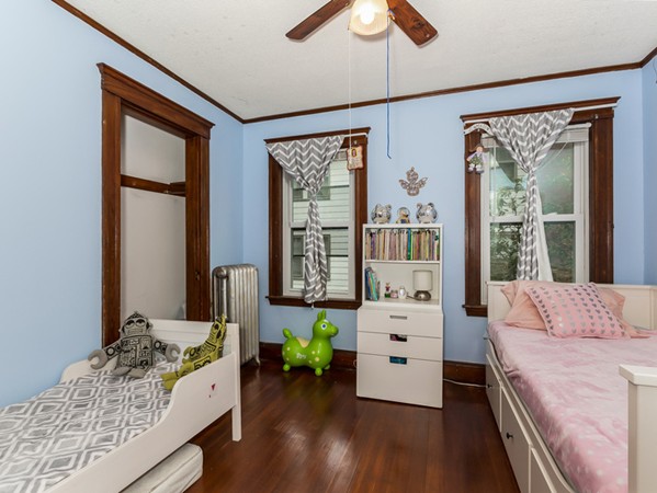 348 Lagrange Street Boston, MA 02132 - Photo 12 of 25 a bedroom with a bed and a large window