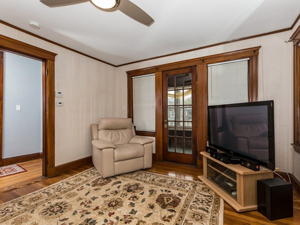 348 Lagrange Street Boston, MA 02132 - Photo 14 of 25 a living room with a flat screen tv and floor to ceiling window