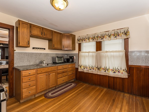 348 Lagrange Street Boston, MA 02132 - Photo 17 of 25 a large kitchen with stainless steel appliances granite countertop a stove and cabinets