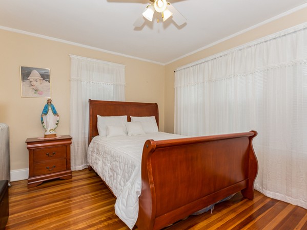 348 Lagrange Street Boston, MA 02132 - Photo 19 of 25 a bed sitting in a room next to a lamp