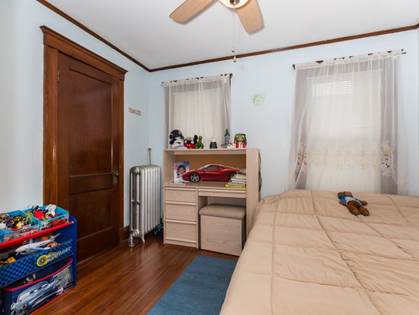348 Lagrange Street Boston, MA 02132 - Photo 21 of 25 a bedroom with a bed and a window