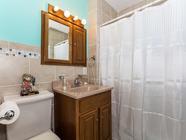 348 Lagrange Street Boston, MA 02132 - Photo 22 of 25 a bathroom with a sink a vanity and a mirror