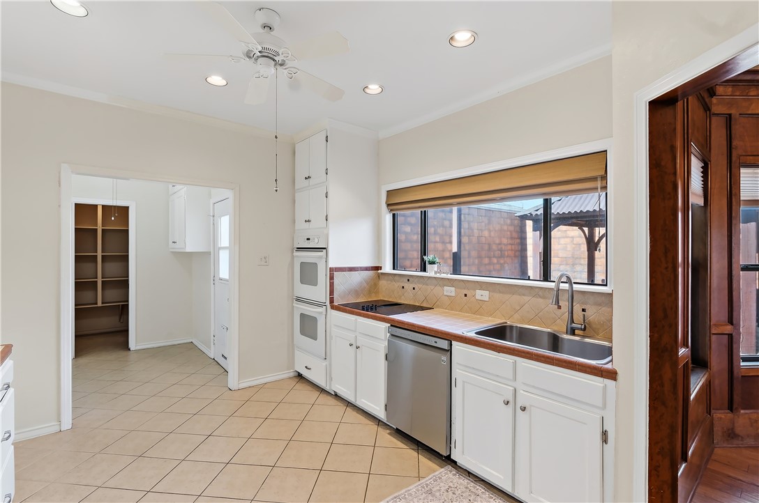 904 Bob White Street Bryan, TX 77802 - Photo 13 of 36 a kitchen with a sink and refrigerator