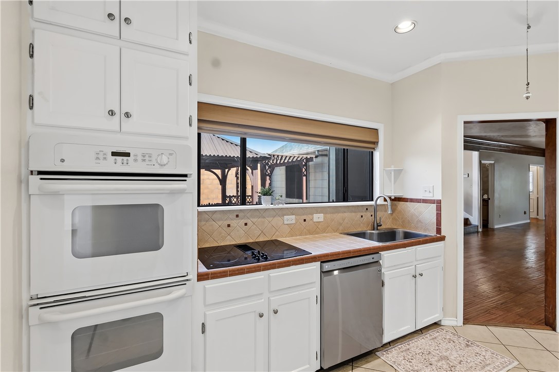 904 Bob White Street Bryan, TX 77802 - Photo 14 of 36 a kitchen with white cabinets and white appliances