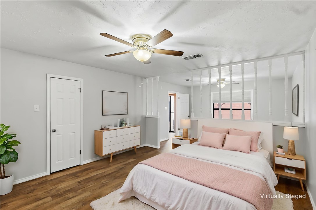 904 Bob White Street Bryan, TX 77802 - Photo 17 of 36 a bedroom with a bed and a chandelier