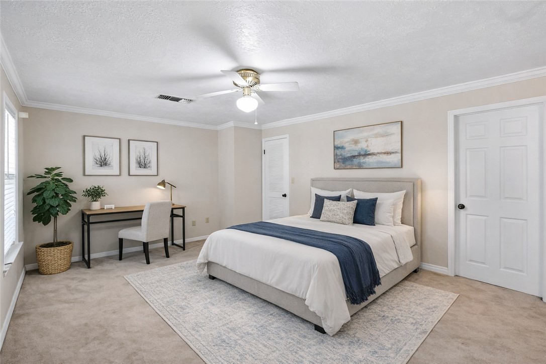 904 Bob White Street Bryan, TX 77802 - Photo 24 of 36 a spacious bedroom with a bed and a table in it