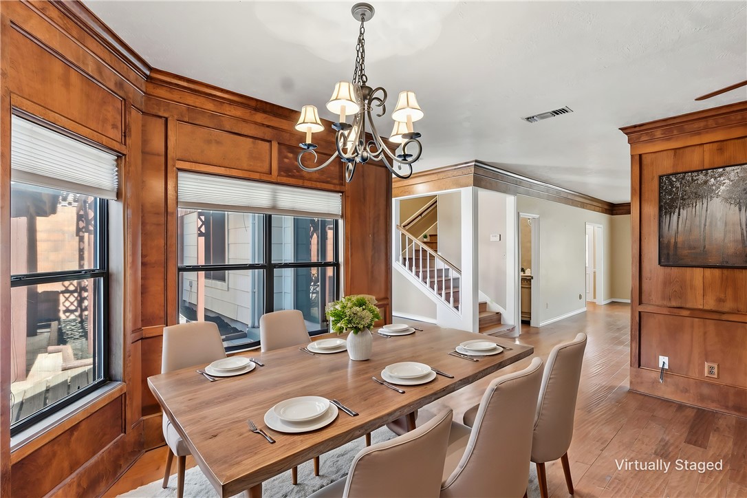 904 Bob White Street Bryan, TX 77802 - Photo 8 of 36 a view of a dining room with furniture a chandelier and wooden floor