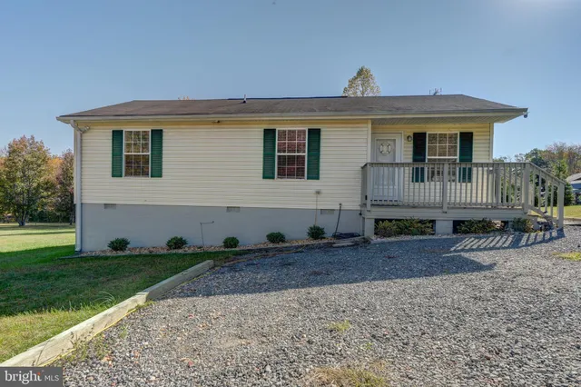 a bedroom with a bed and a flat tv screen on dresser