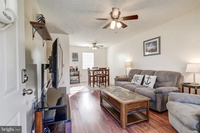 a view of a wooden chairs and table in the backyard