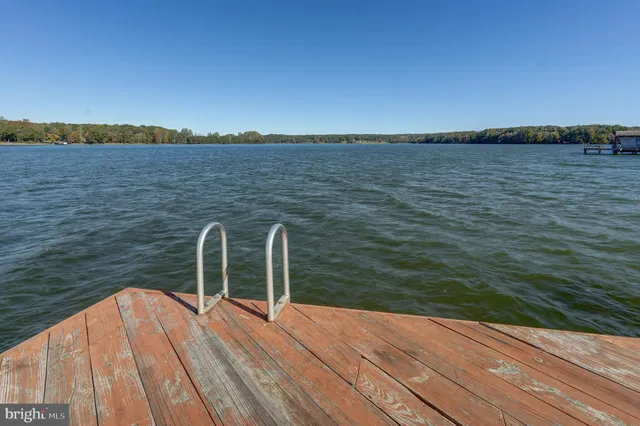 a living room with furniture a ceiling fan and a window