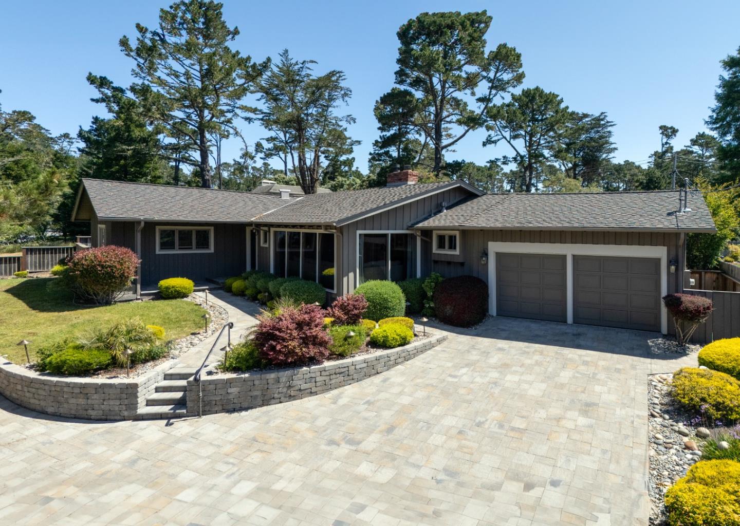 a front view of a house with a yard and seating space