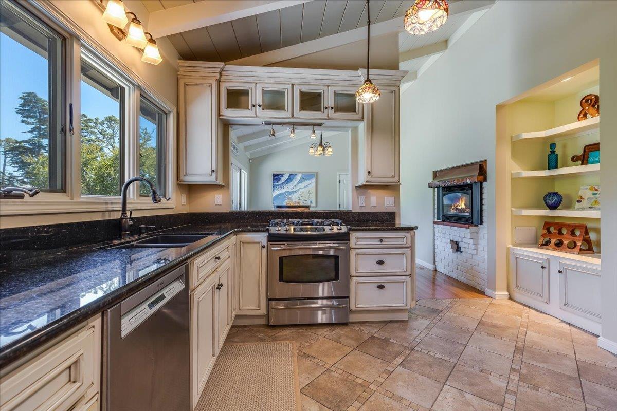 4117 Sunridge Road Pebble Beach, CA 93953 - Photo 11 of 46 a kitchen with stainless steel appliances granite countertop a stove and a sink