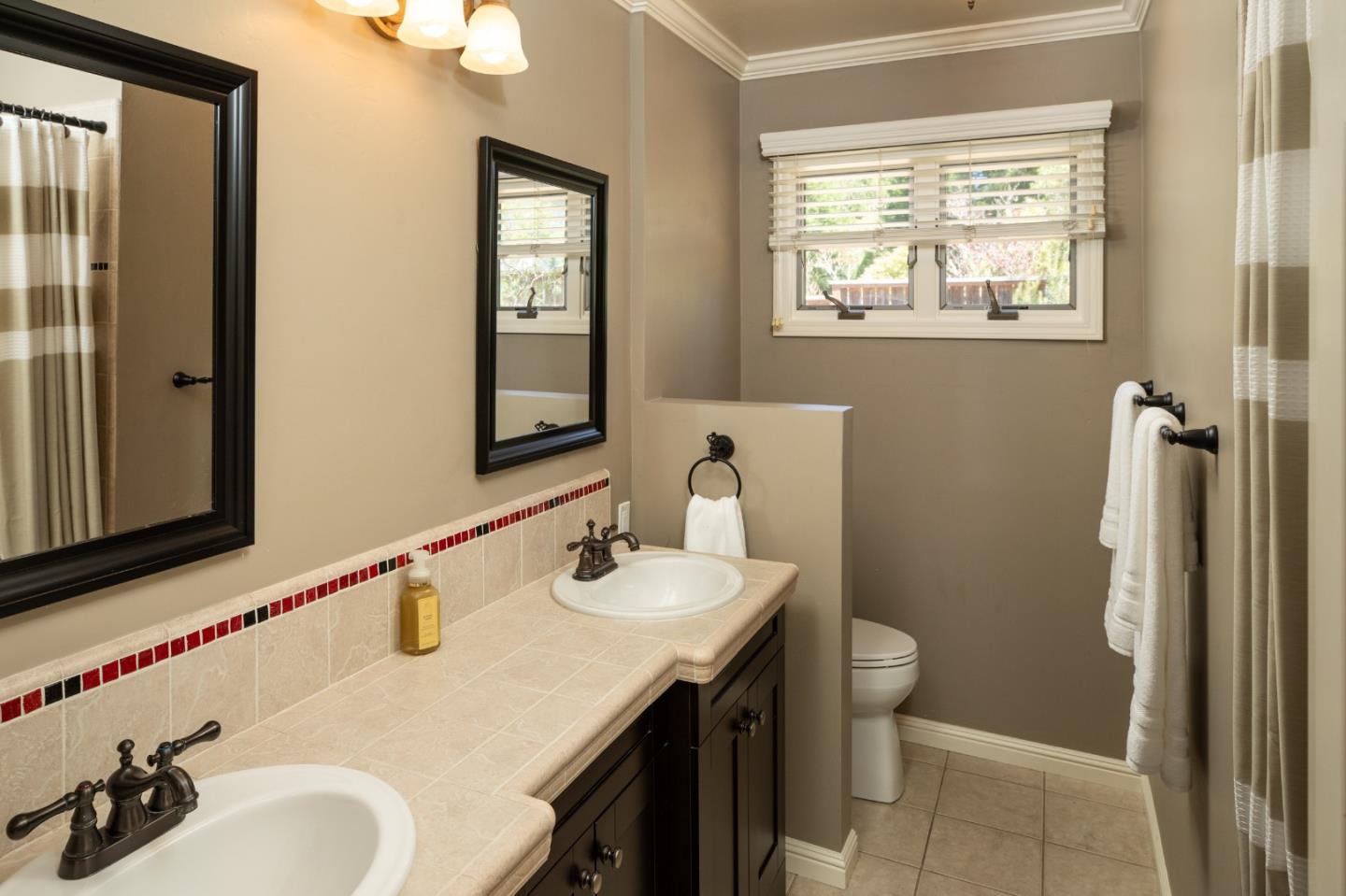 4117 Sunridge Road Pebble Beach, CA 93953 - Photo 19 of 46 a bathroom with a sink and a mirror
