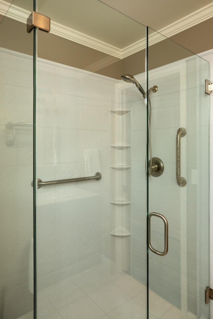 4117 Sunridge Road Pebble Beach, CA 93953 - Photo 23 of 46 a bathroom with a glass shower door