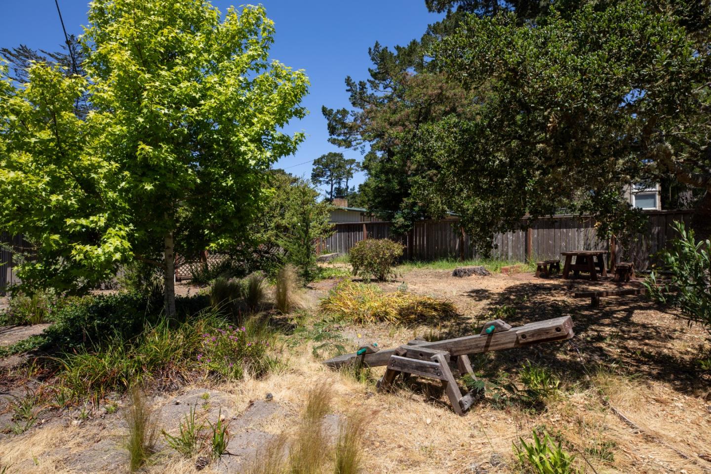 4117 Sunridge Road Pebble Beach, CA 93953 - Photo 35 of 46 a backyard of a house with table and chairs