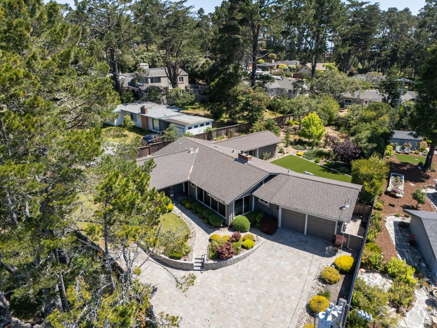 4117 Sunridge Road Pebble Beach, CA 93953 - Photo 37 of 46 an aerial view of a house with a swimming pool and large trees