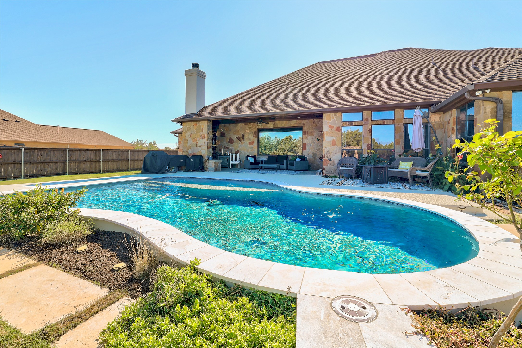 Undisclosed Address Georgetown, TX 78633 - Photo 4 of 39 a view of a house with a yard patio and a garden